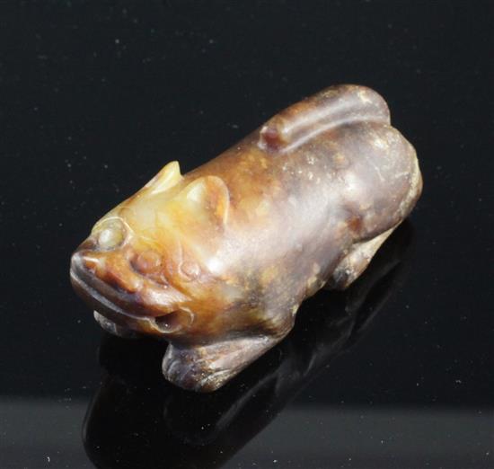 A Chinese celadon and brown jade figure of a recumbent lion-dog, Song dynasty or later, 5.7cm